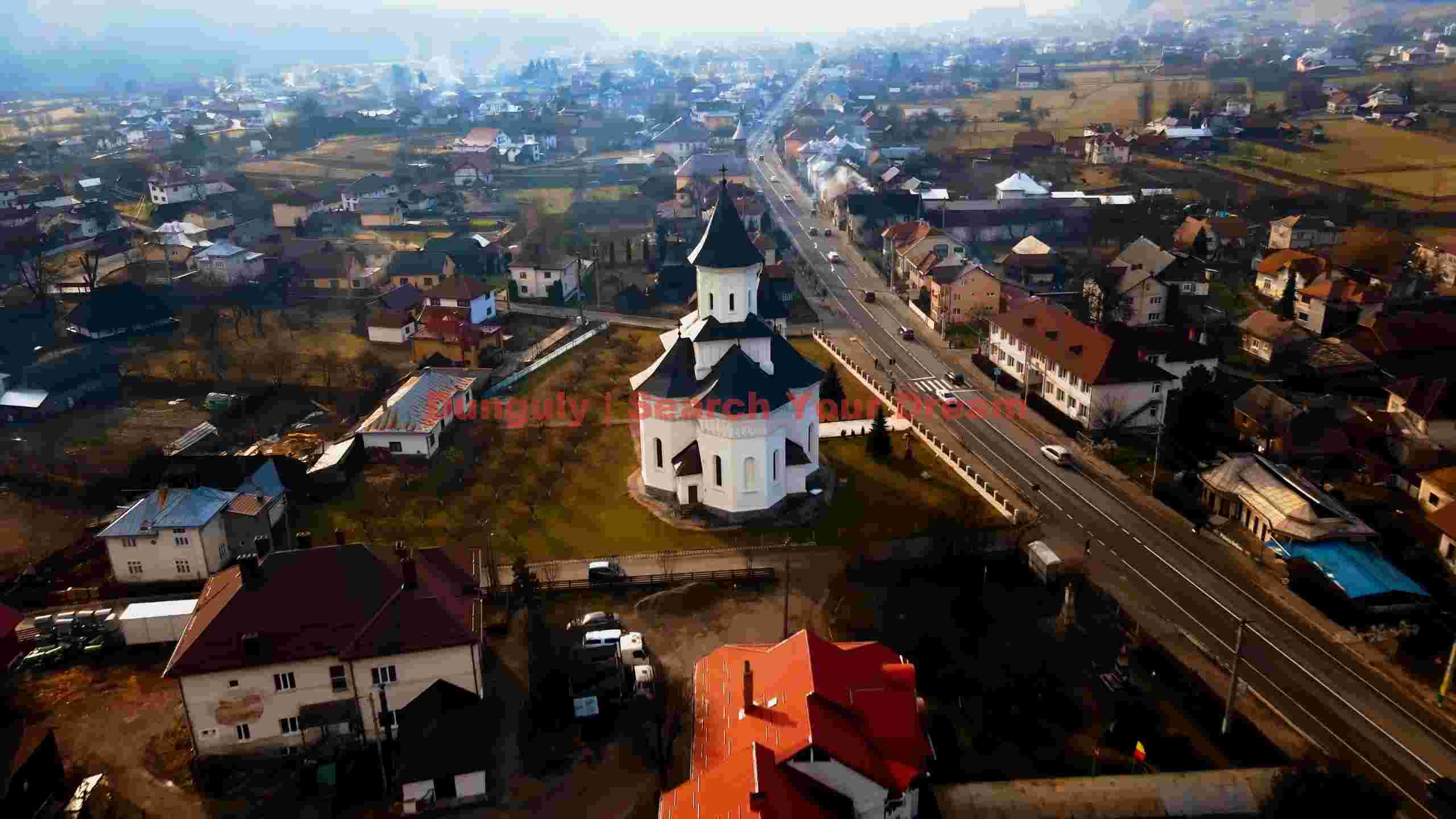 aerial view of historic european village and church aerial view of historic european village and church