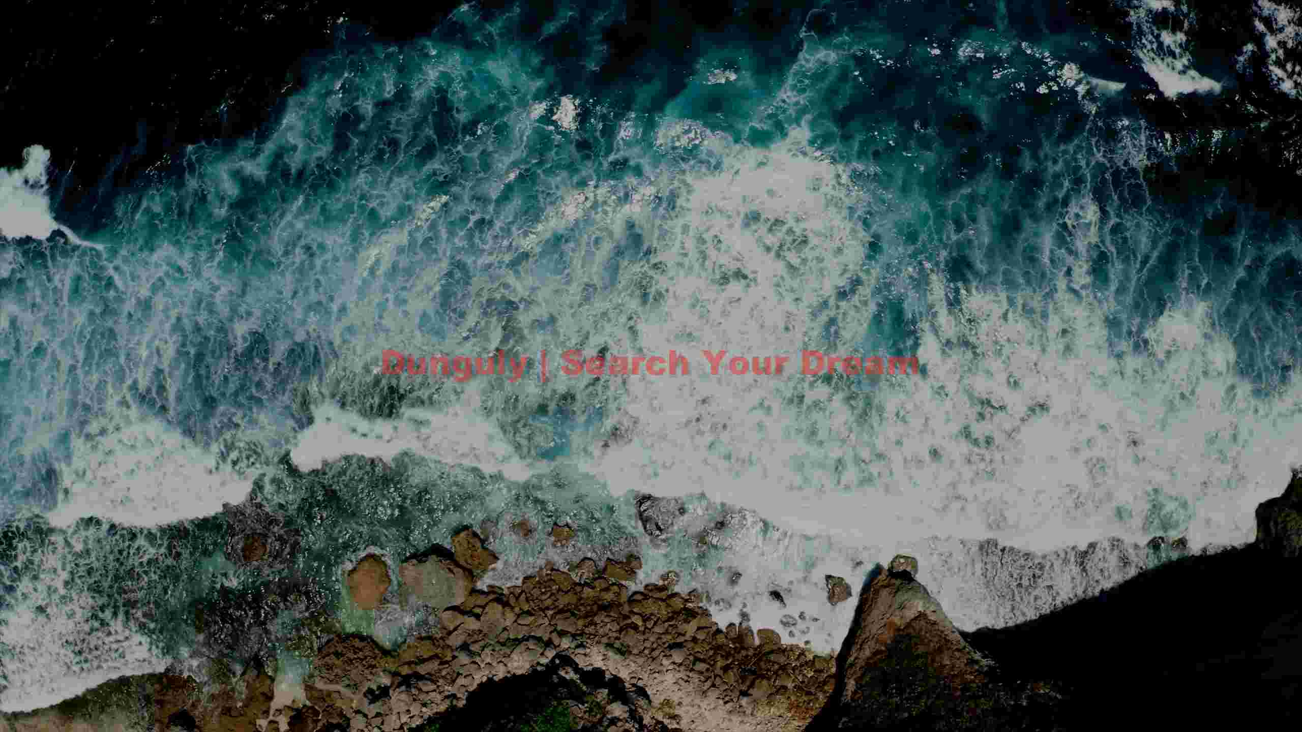 aerial view of turquoise ocean waves on rocky coast aerial view of turquoise ocean waves on rocky coast