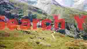 alpine leisure hikers on grassy mountain slopes