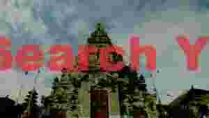 ancient balinese temple gate under cloudy skies