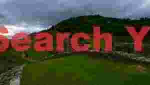 At Home ancient castle ruins on verdant hills under overcast skies