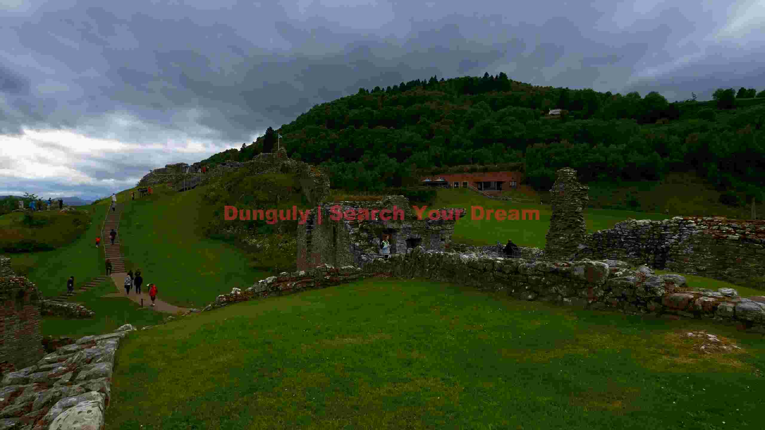 ancient castle ruins on verdant hills under overcast skies ancient castle ruins on verdant hills under overcast skies