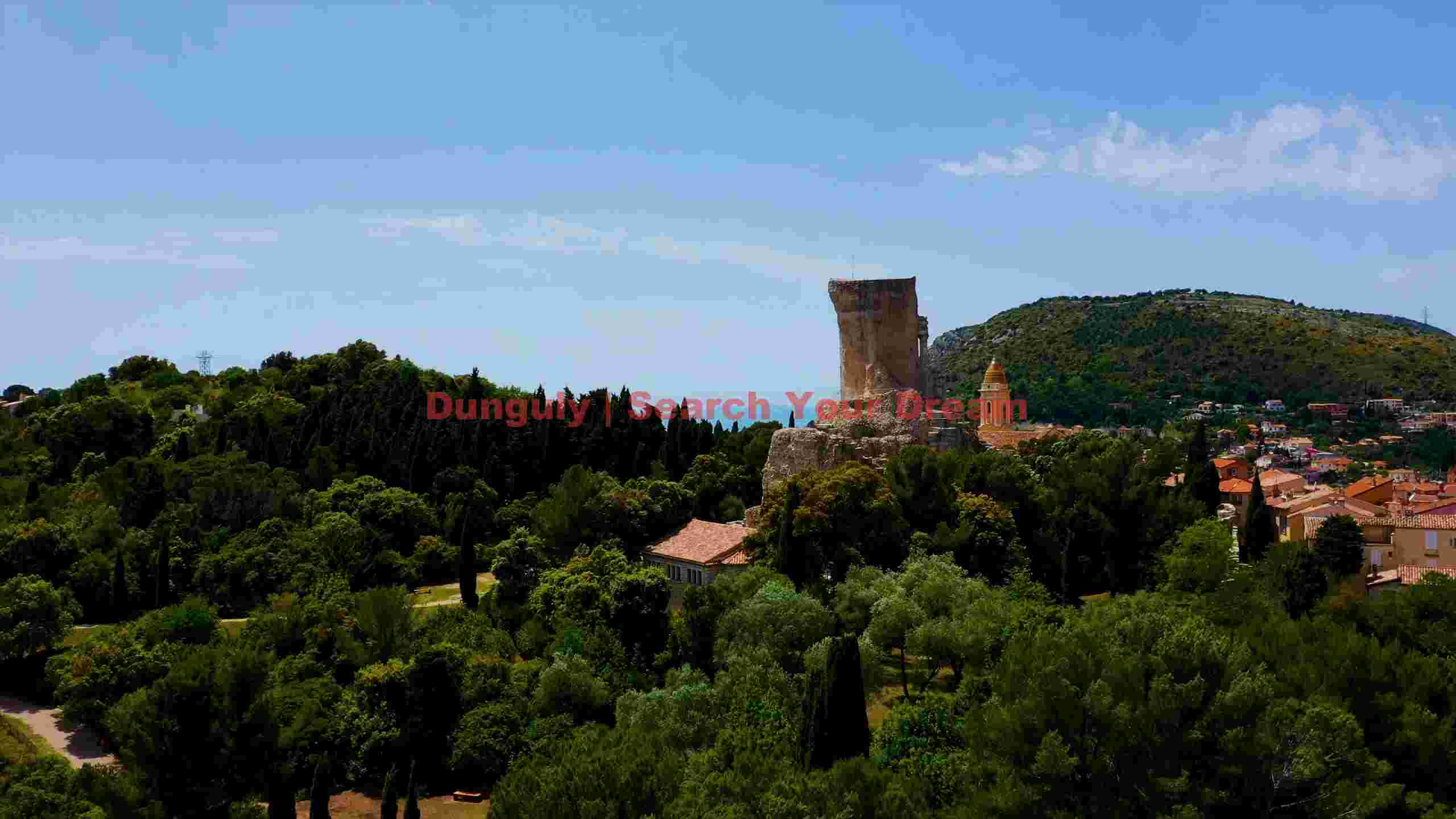 ancient tower overlooking mediterranean village ancient tower overlooking mediterranean village