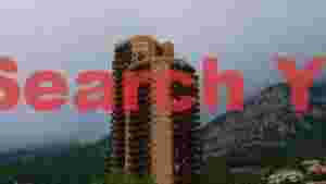 coastal high rise amidst misty mountains