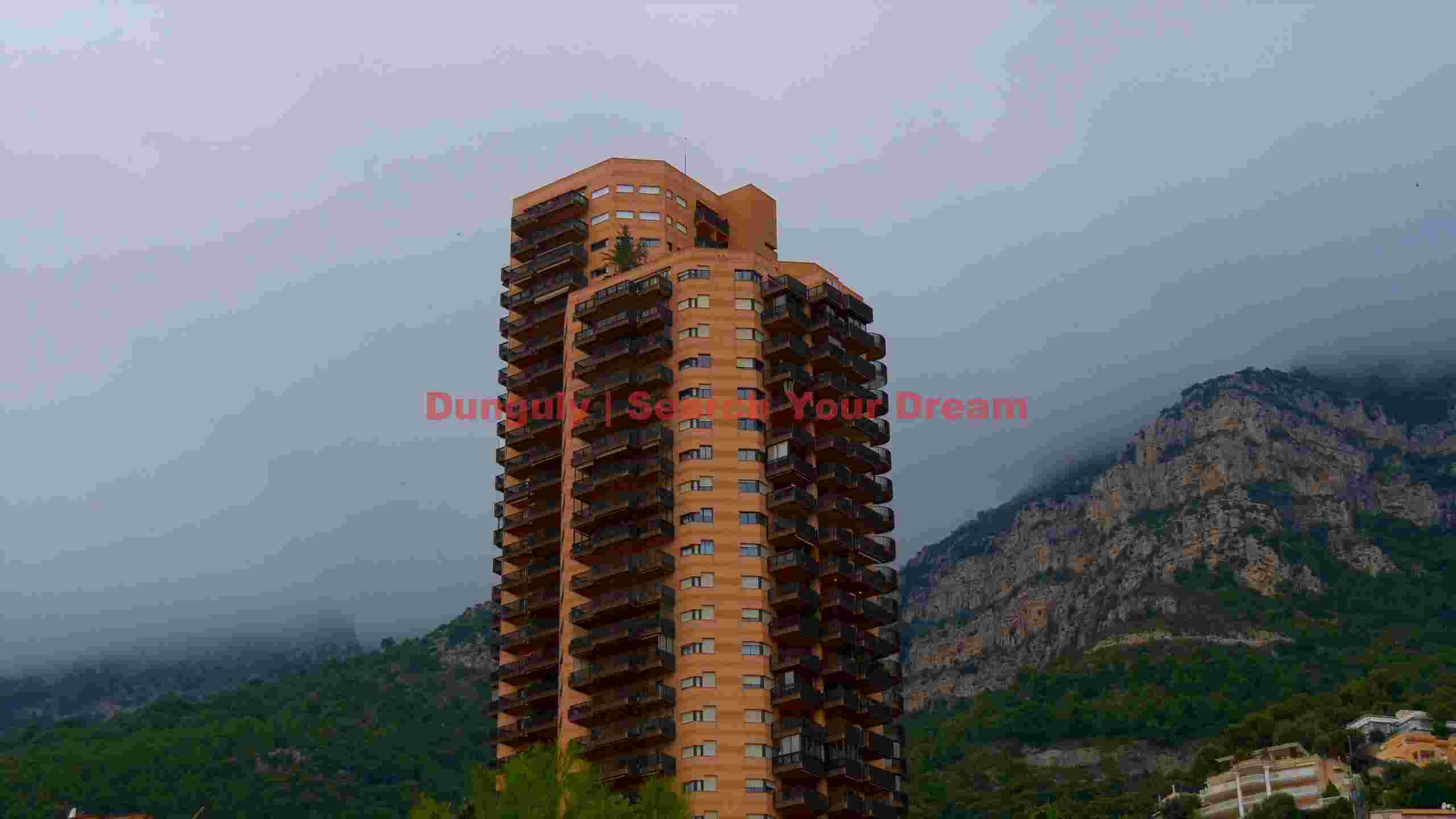 coastal high rise amidst misty mountains coastal high rise amidst misty mountains