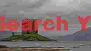 dramatic scottish castle on a rainy loch