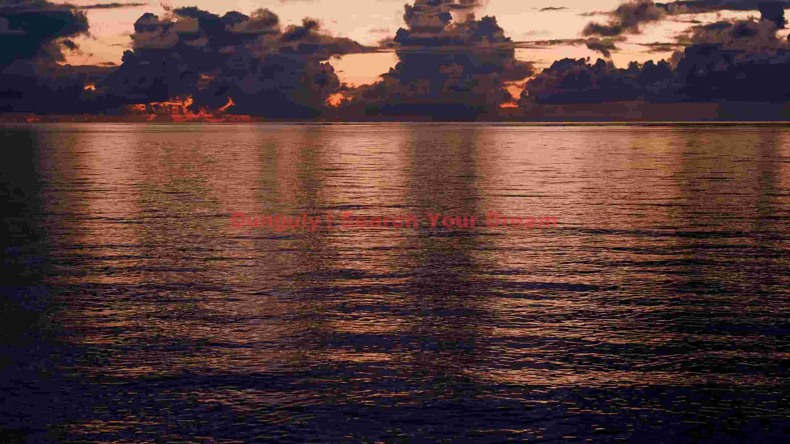 dramatic sunset over tranquil ocean dramatic sunset over tranquil ocean