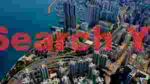 At Home dynamic coastal cityscape aerial view