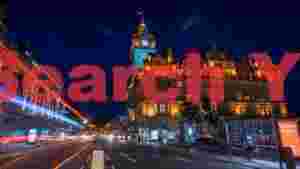 dynamic edinburgh night historic clock tower and urban light trails