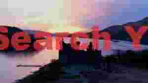 ethereal sunset over historic scottish loch