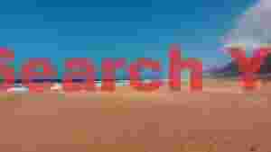 expansive golden beach with ocean waves and distant mountains