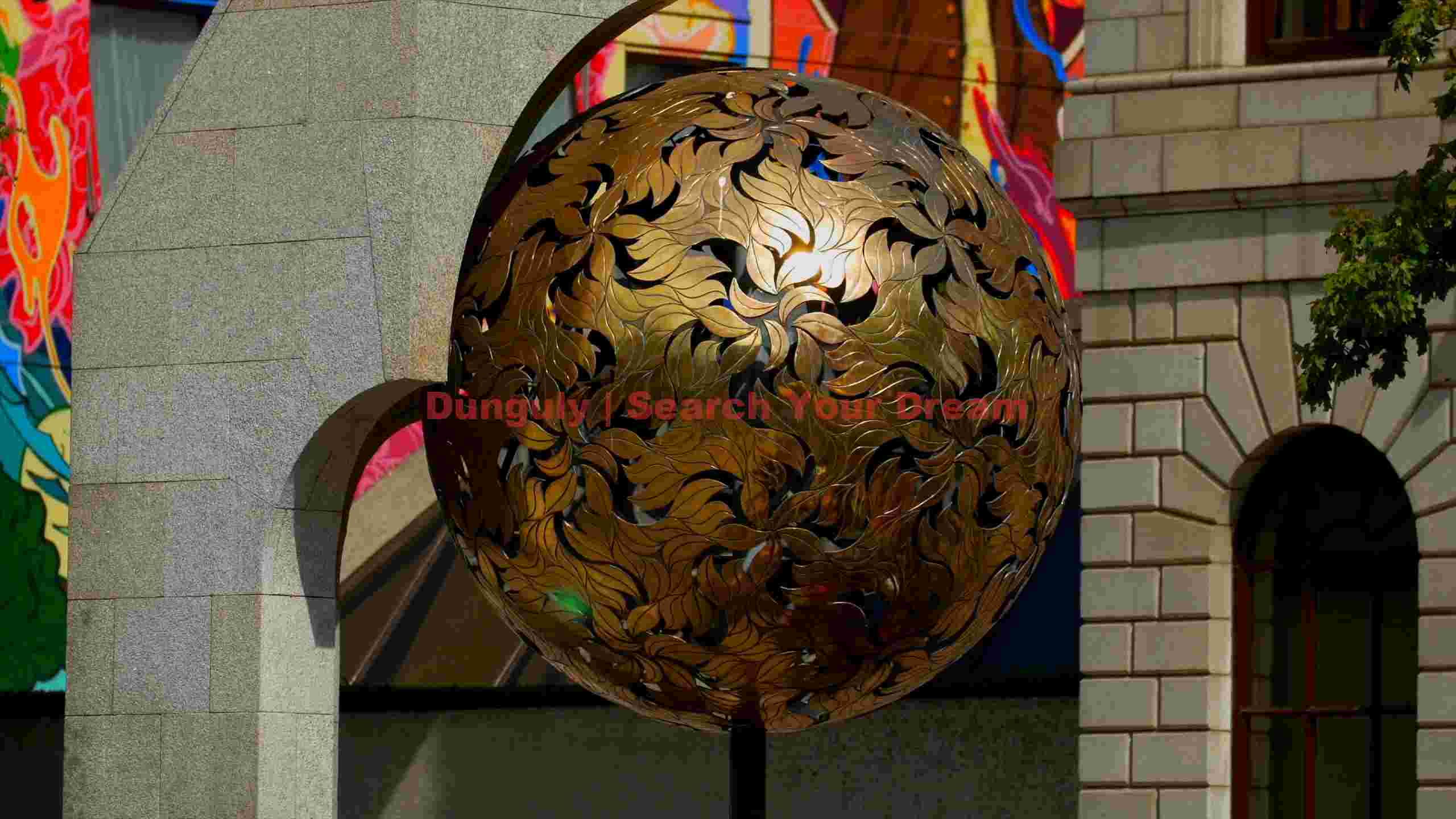 glistening golden leaf sculpture in urban setting glistening golden leaf sculpture in urban setting