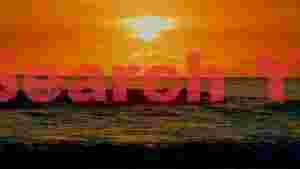 golden ocean sunset with surfers