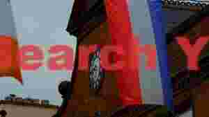 historic clock tower adorned with national flags