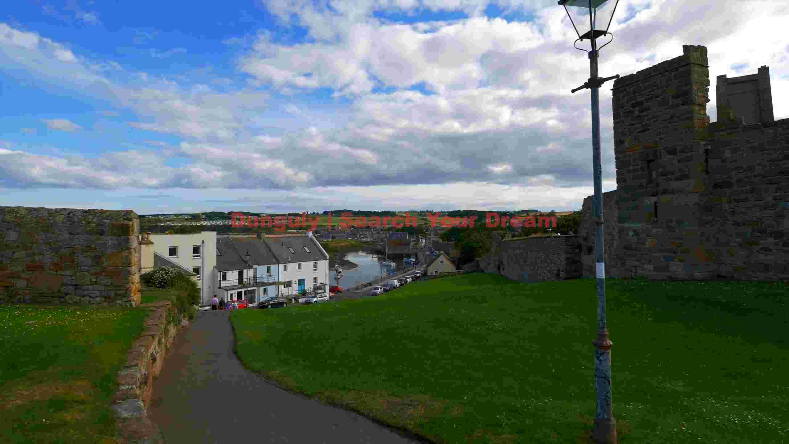 historic coastal town vista with castle ruins historic coastal town vista with castle ruins