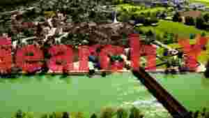 At Home historic european riverside town aerial panorama