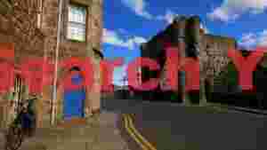 historic st andrews street with ancient arch and blue door