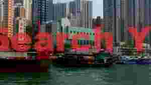 hong kong harbor urban vista with traditional boats