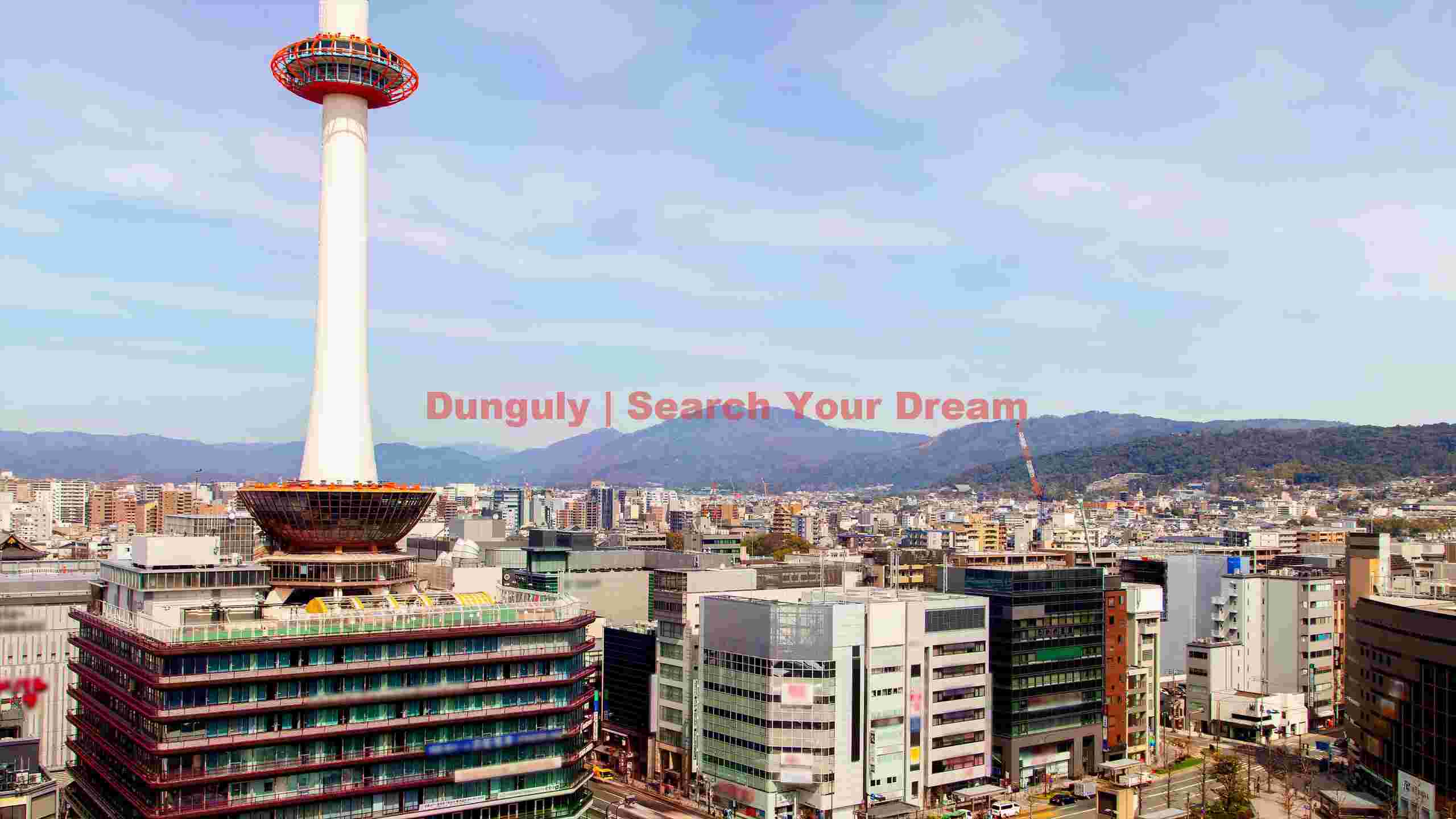 kyoto tower dominating urban skyline with mountains kyoto tower dominating urban skyline with mountains