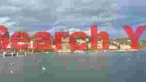 lakeside cityscape under dramatic skies