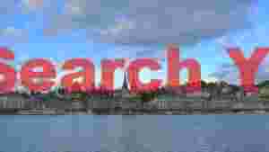 lakeside cityscape with historic twin spires