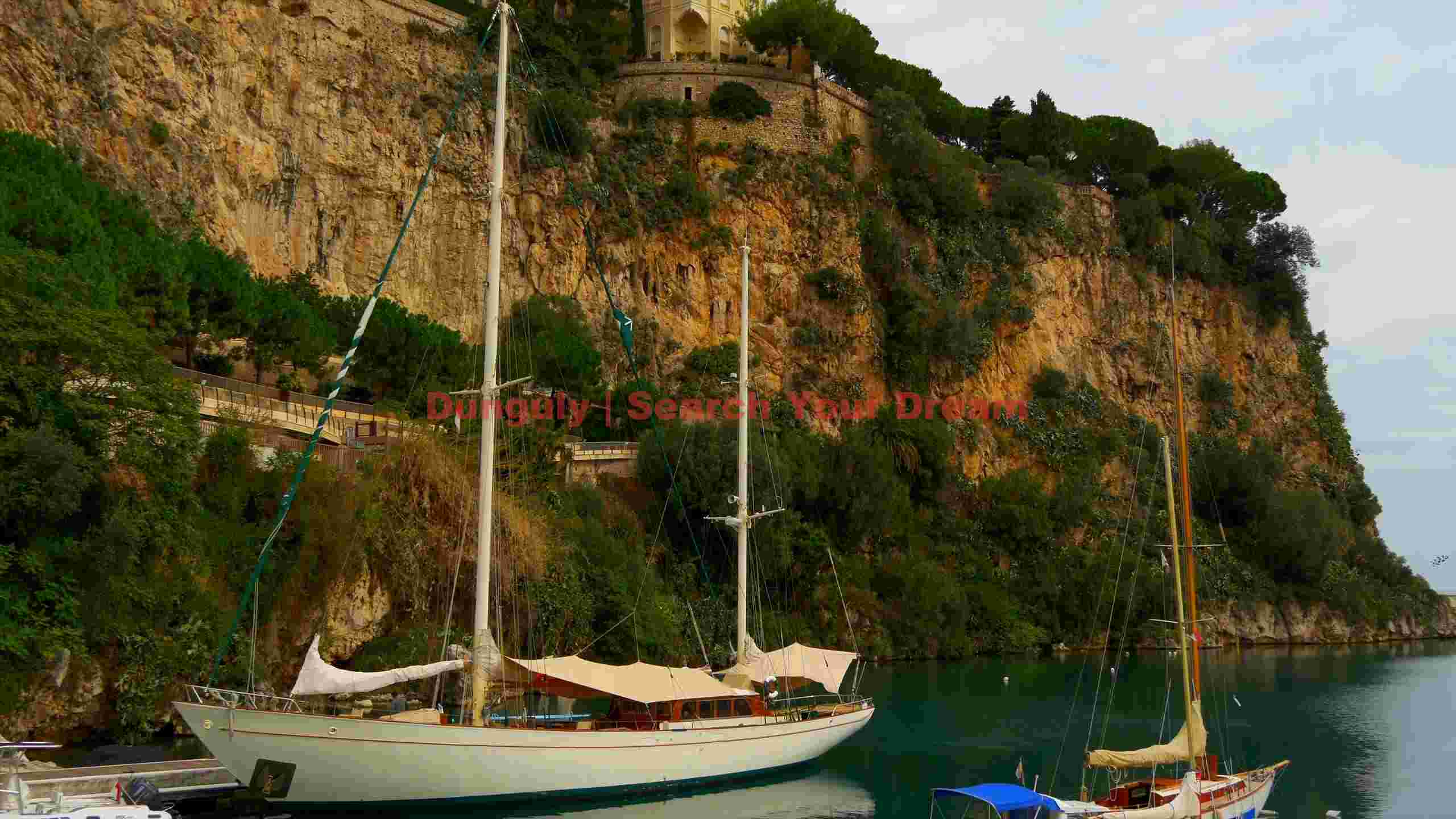 mediterranean harbor sailboats beneath majestic cliffs mediterranean harbor sailboats beneath majestic cliffs