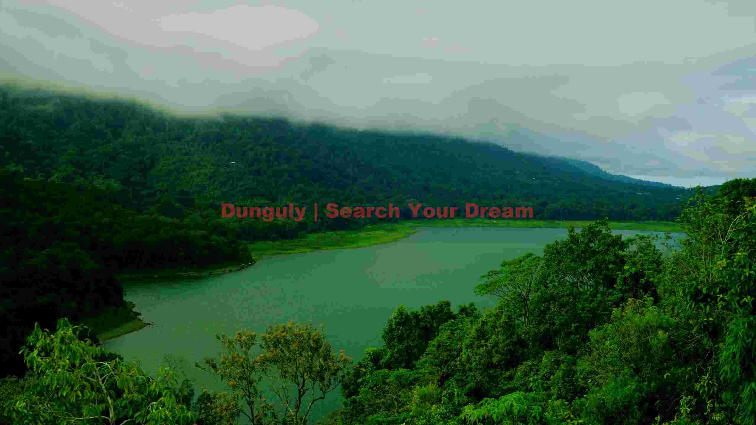 misty green lake amidst lush mountains misty green lake amidst lush mountains
