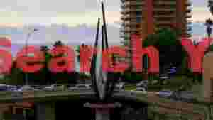 At Home monaco coastal view with striking modern sculpture