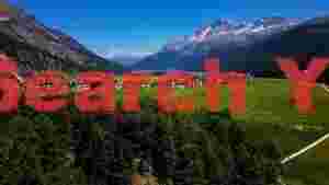 panoramic alpine valley and turquoise lake village
