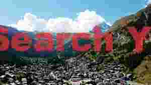 At Home panoramic alpine village and mountain vista