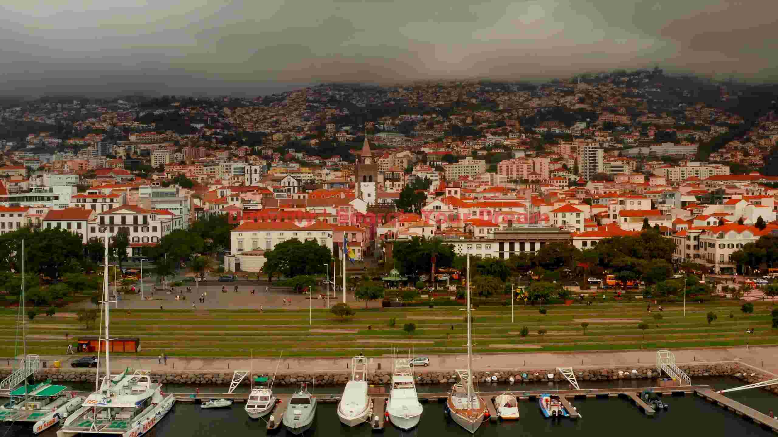panoramic funchal cityscape and marina on a cloudy day panoramic funchal cityscape and marina on a cloudy day