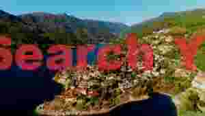 At Home panoramic lakeside village amidst mountains
