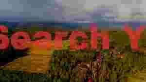 panoramic rural village and golden rice fields