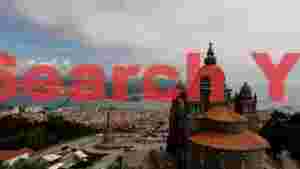 At Home panoramic vista of sacred heights and coastal city