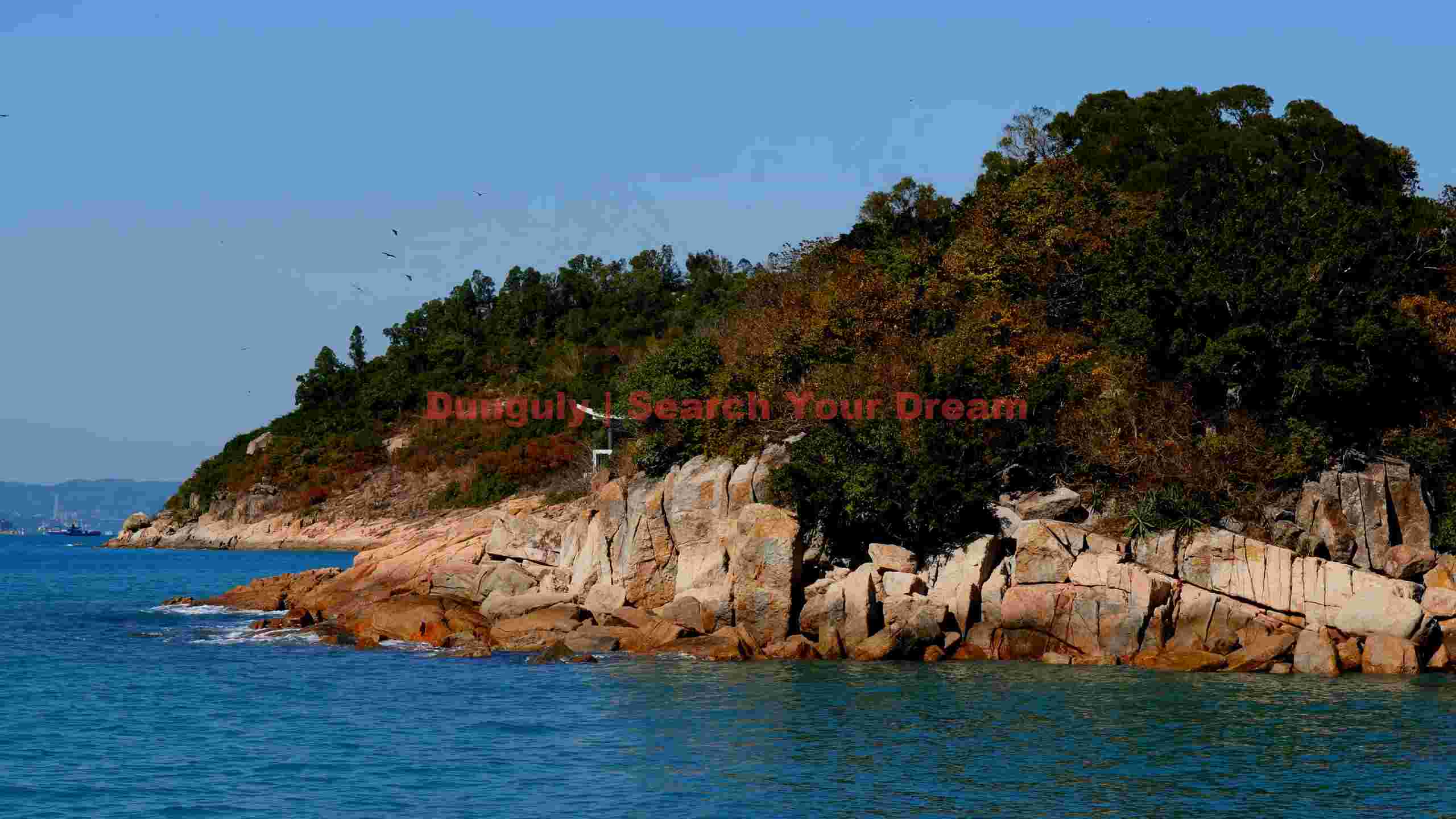 rugged island coastline with autumnal foliage rugged island coastline with autumnal foliage