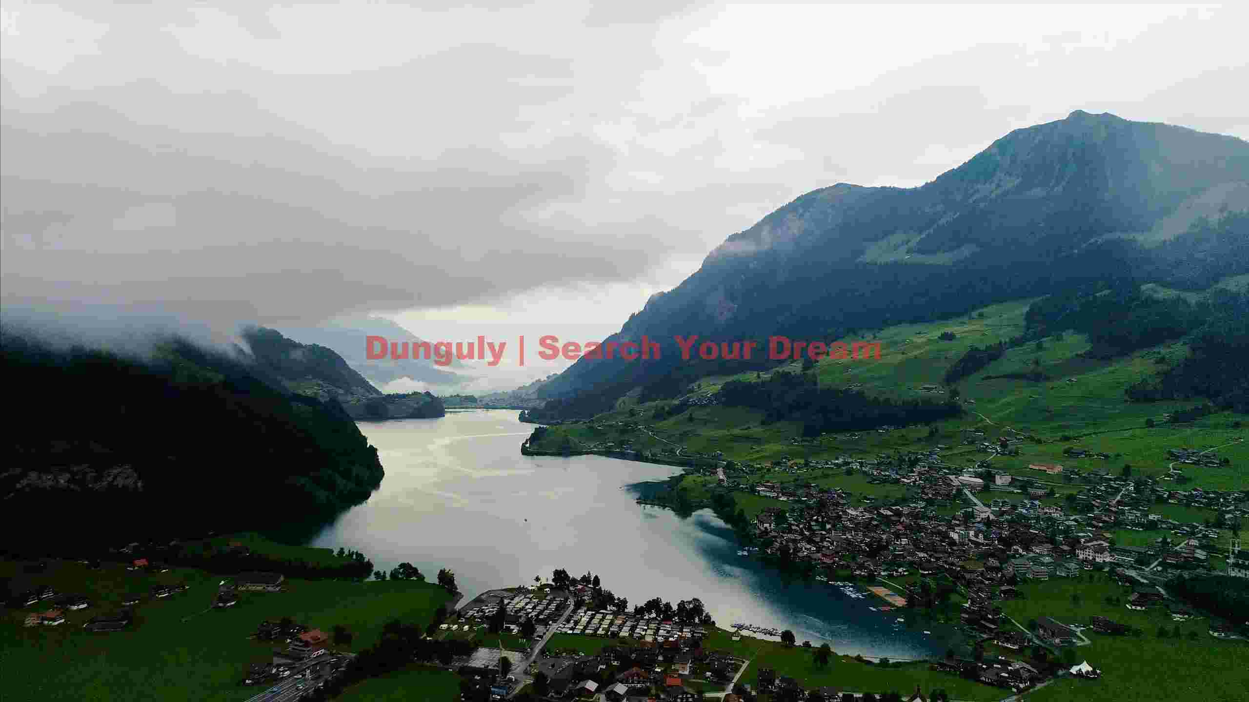 serene alpine lake village under cloudy skies serene alpine lake village under cloudy skies