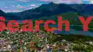 serene lakeside town amidst majestic mountains