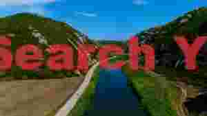 serene river valley cycling path and majestic green mountains