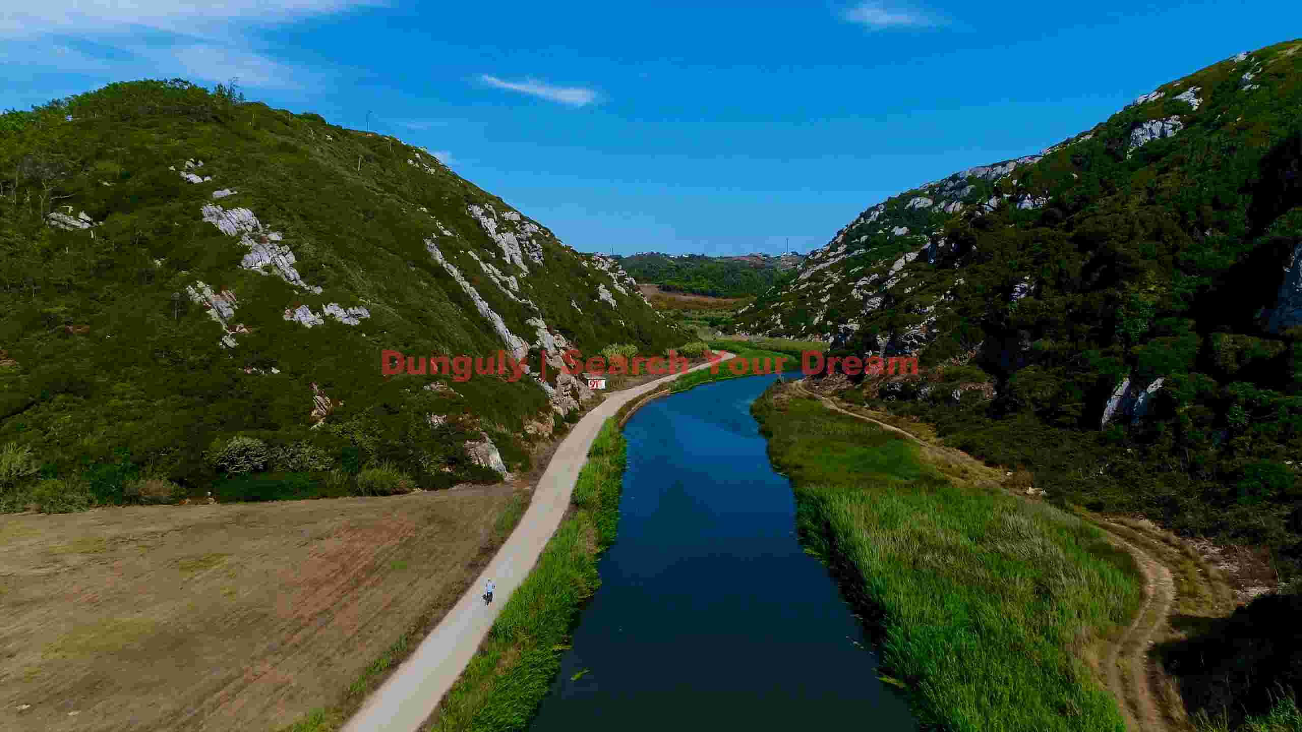 serene river valley cycling path and majestic green mountains serene river valley cycling path and majestic green mountains