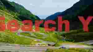 serpentine mountain pass in lush green valley