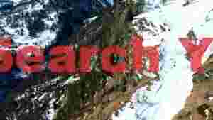 snowy alpine valley with forest and cliffs