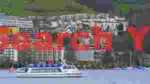 At Home swiss lake boat tour with hillside city panorama