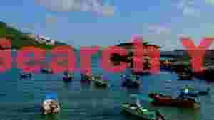 tranquil coastal bay with fishing boats and green hills