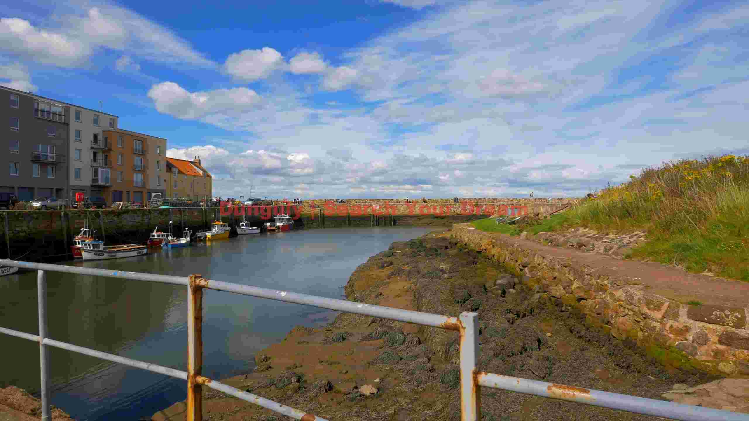 tranquil coastal harbor with fishing boats tranquil coastal harbor with fishing boats