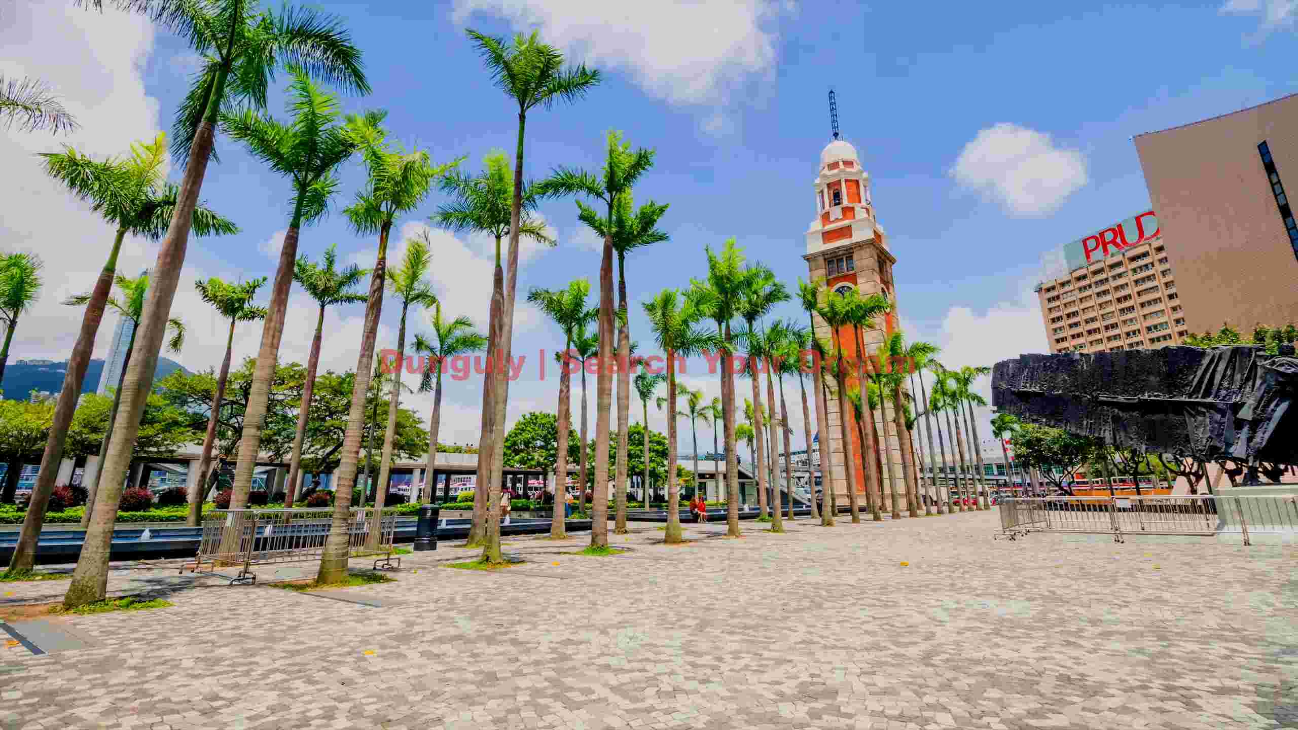 tsim sha tsui clock tower and palm trees in hong kong tsim sha tsui clock tower and palm trees in hong kong