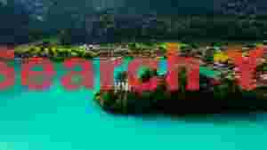 At Home turquoise alpine lake village view