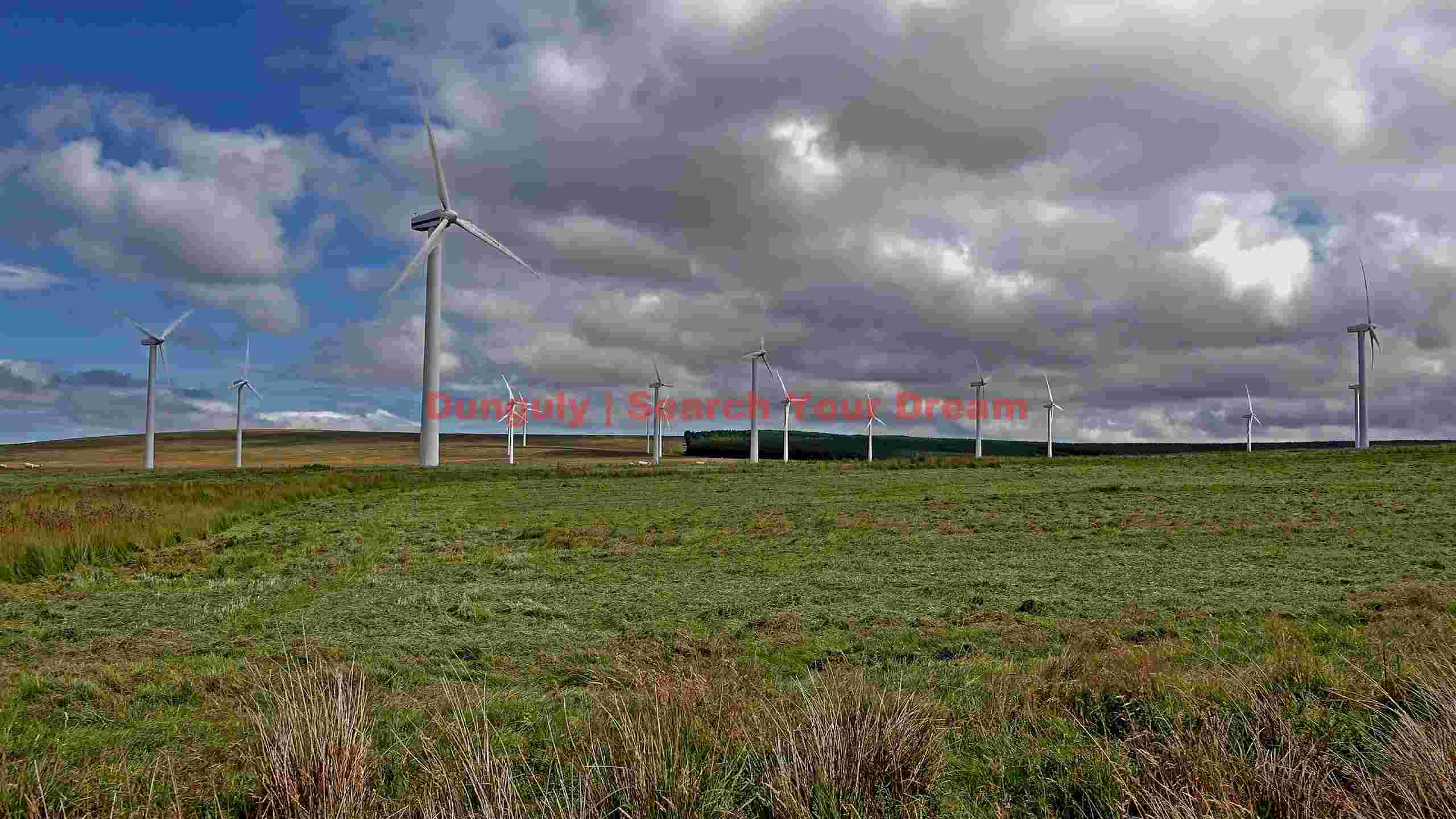 vast wind farm on a green hillside under a dynamic sky vast wind farm on a green hillside under a dynamic sky