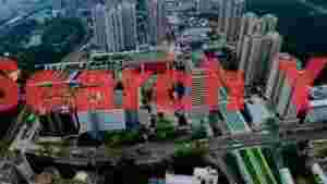 At Home vibrant aerial cityscape over green parks