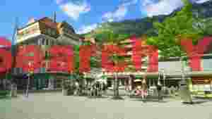 At Home vibrant alpine village square in summer