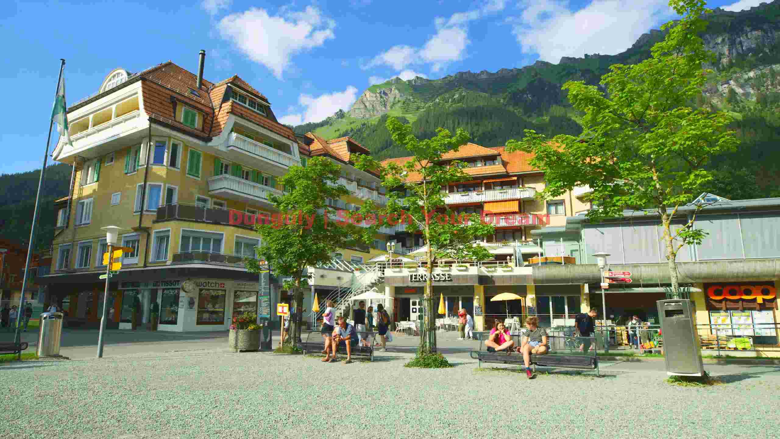 vibrant alpine village square in summer vibrant alpine village square in summer
